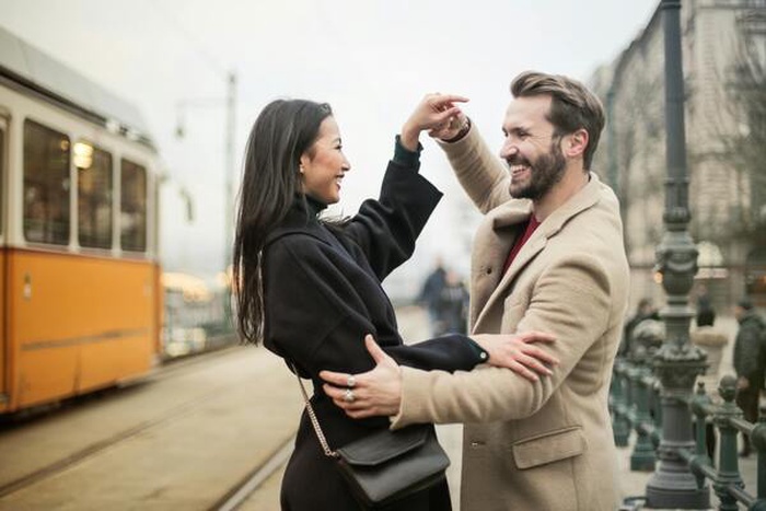 A couple dancing on the sidewalk