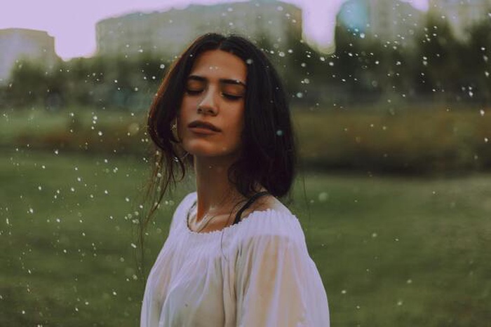 Woman in white shirt on green background